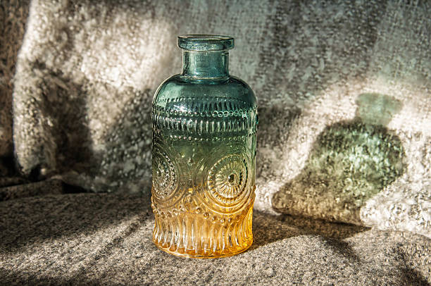 glass bottle with a gradient from teal to amber