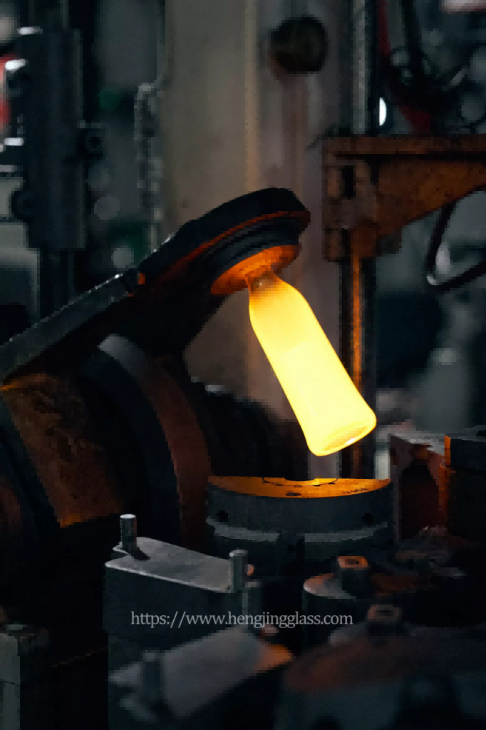 Glass bottle manufacturing process showing molten glass forming into 750ml liquor bottle(1)